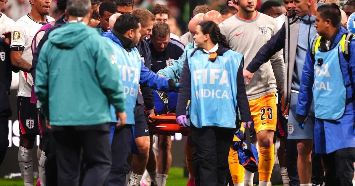 Medical staff assisting injured player off the field