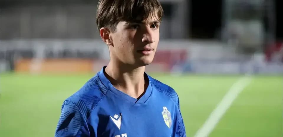 Young player in blue jersey on football pitch