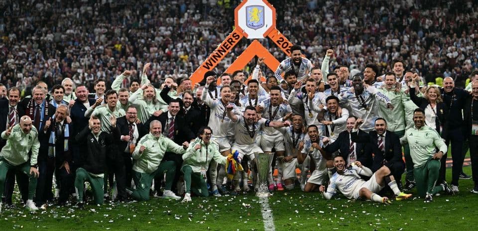 Aston Villa players celebrating with trophy after victory