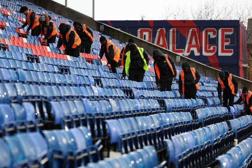 Staff preparing empty stadium seats for event