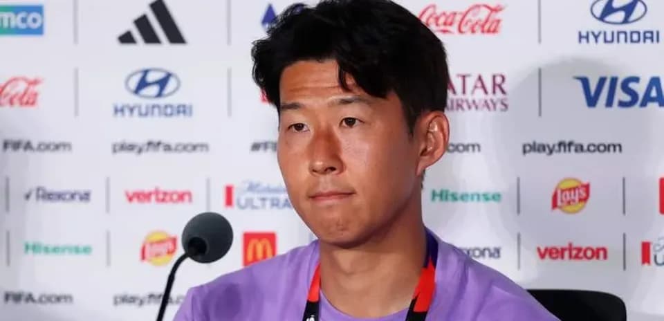 Player speaking at press conference with sponsor logos