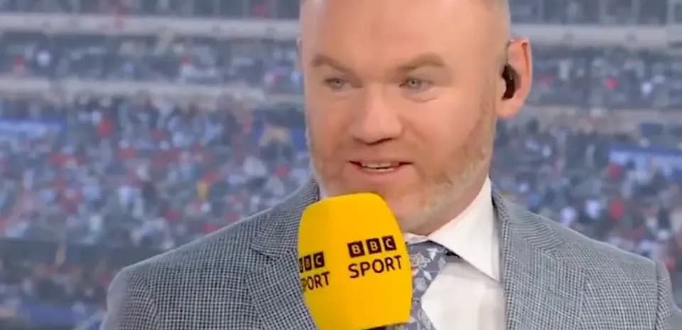 Sports commentator speaking with microphone on set