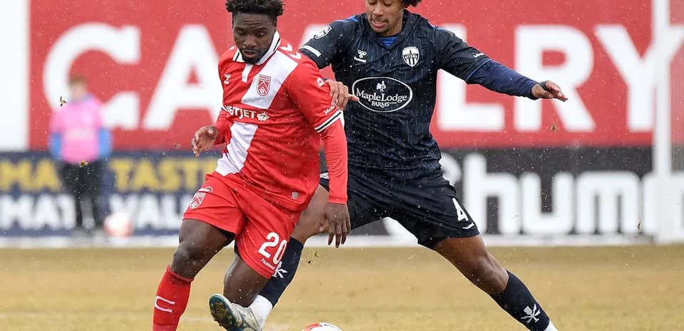 Players contesting for the ball during match