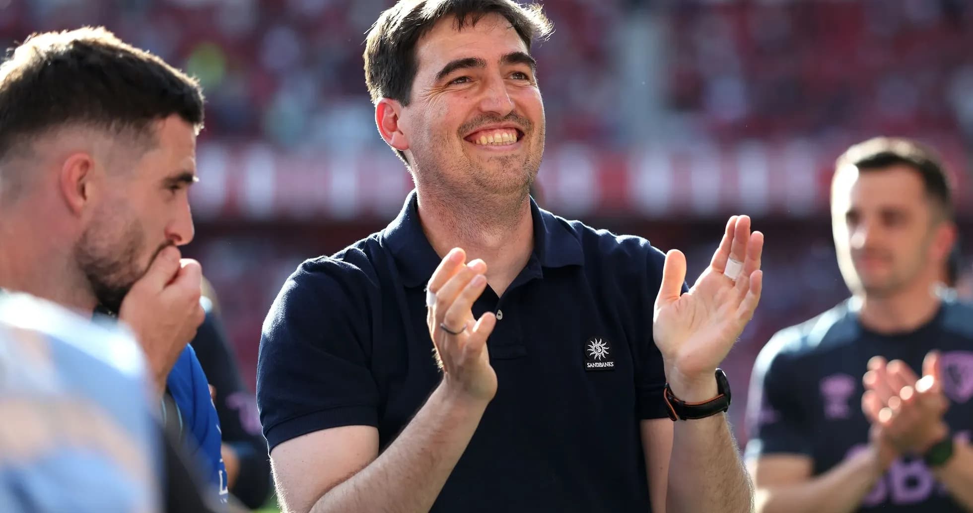 Manager applauding during match celebration with players
