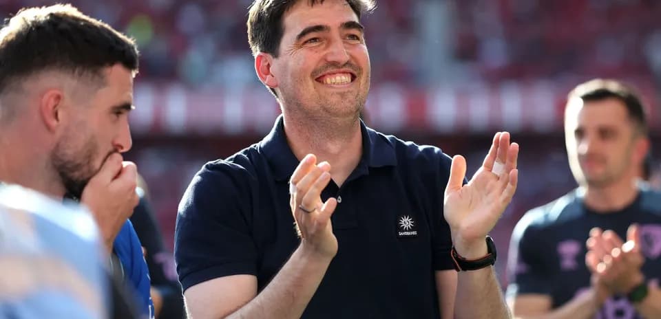 Manager applauding during match celebration with players