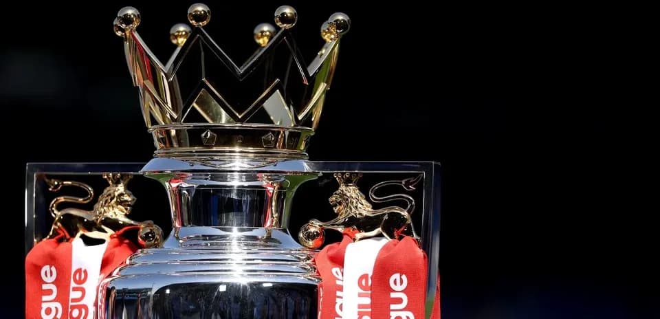 Premier League trophy with red ribbons and crown