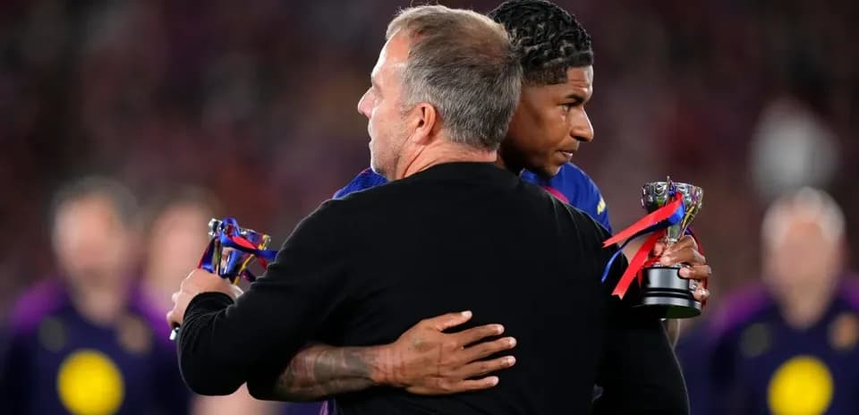 Coach embracing player with trophies after match