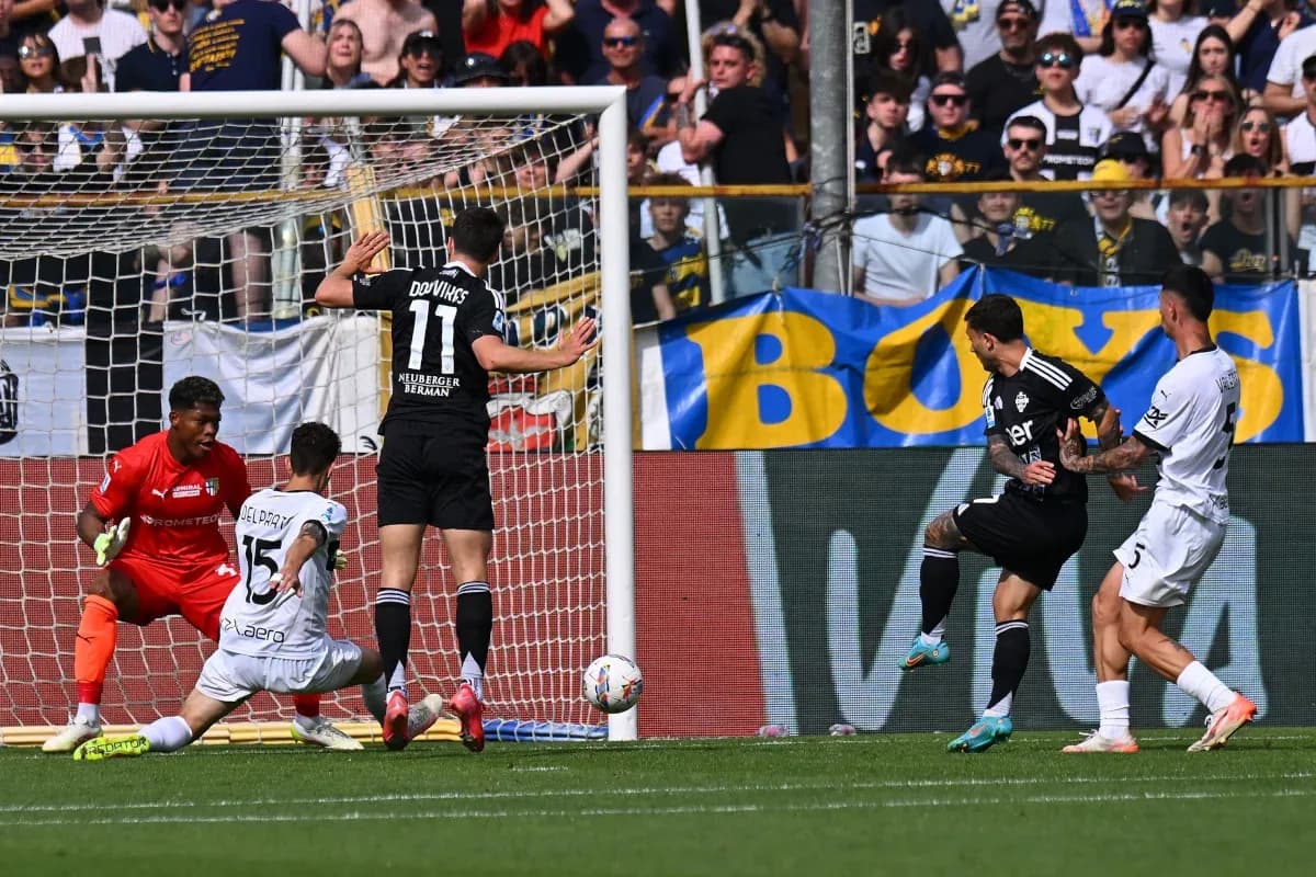 Como player shooting at goal against Parma