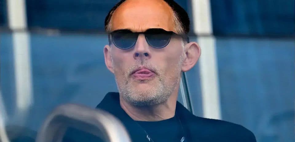 Man wearing sunglasses in a stadium box