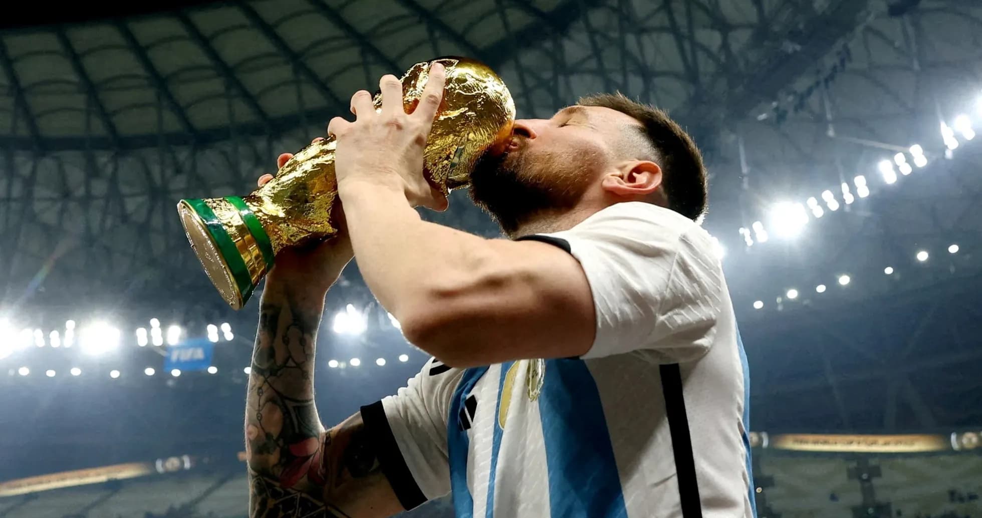 Player celebrating by kissing the World Cup trophy