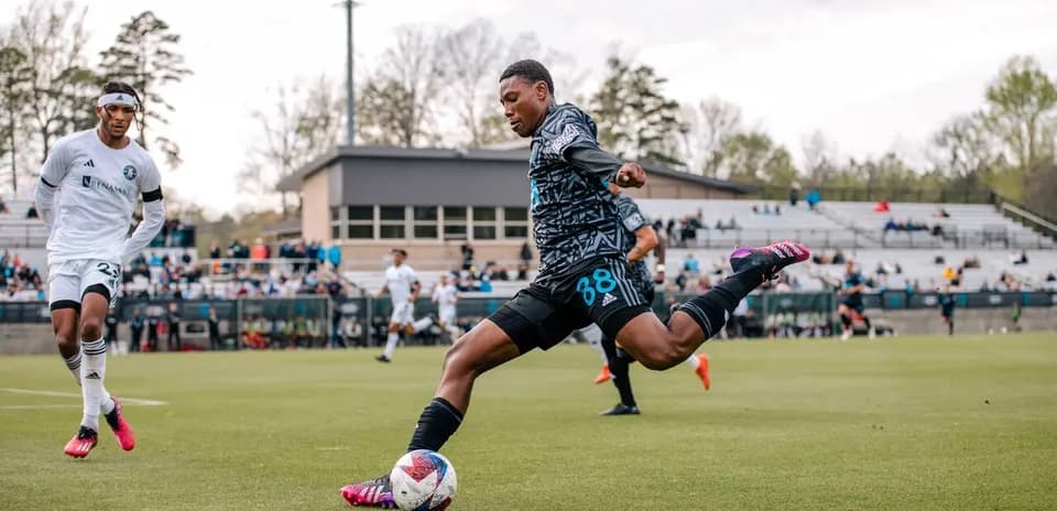 Player kicking the ball during Huntsville City match