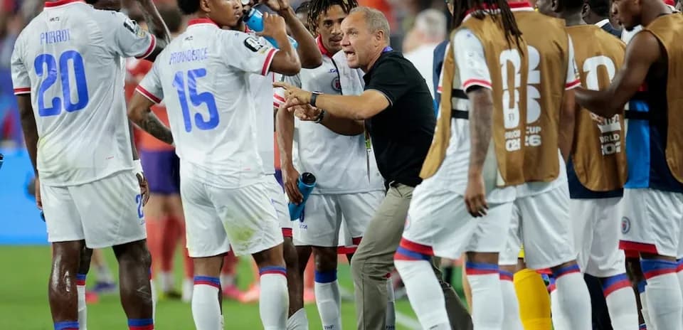 Haitian team discussing strategy during a match