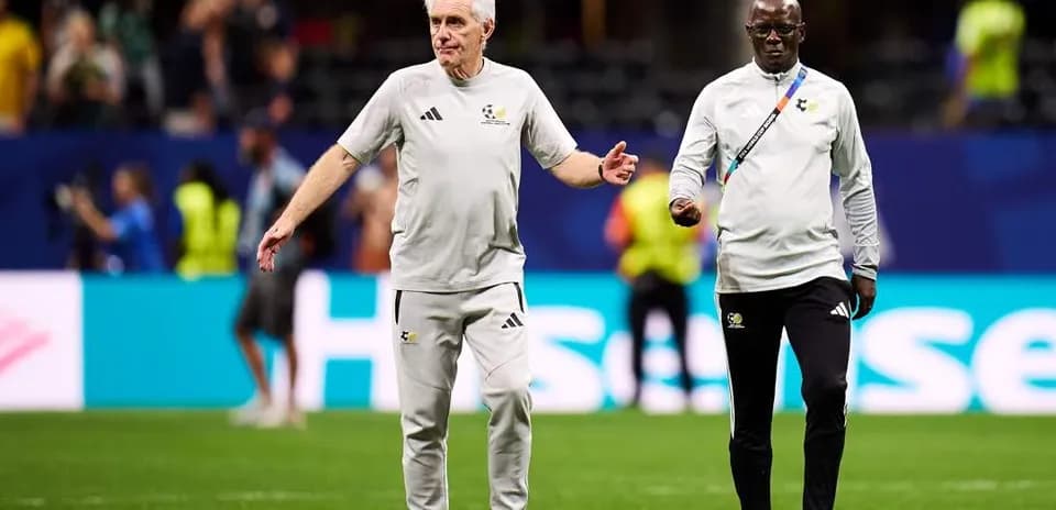 Coaches walking on the field before a match