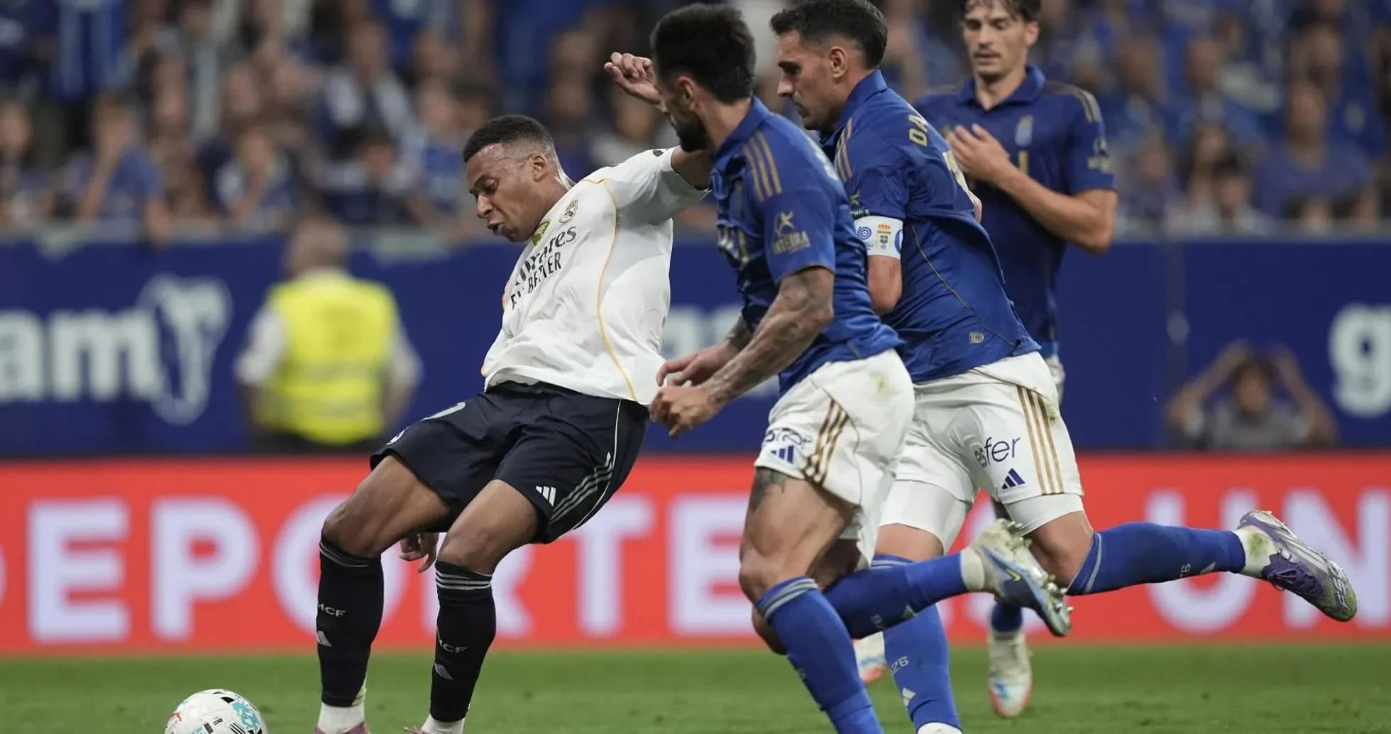 Real Madrid player tackled by Oviedo defenders