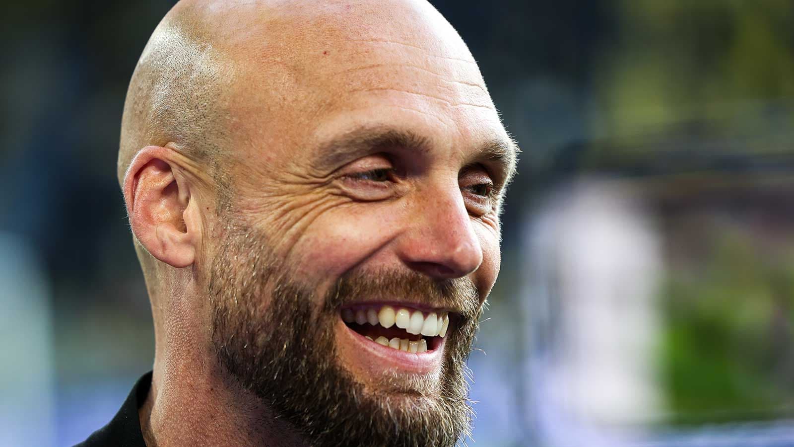 Smiling man with a beard and bald head