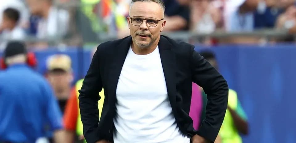 Coach walking along the sidelines during a match