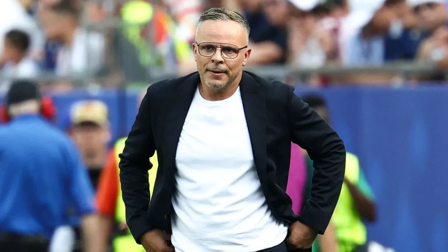 Coach walking along the sidelines during a match