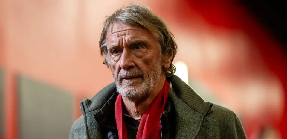 Man wearing a gray coat and red scarf