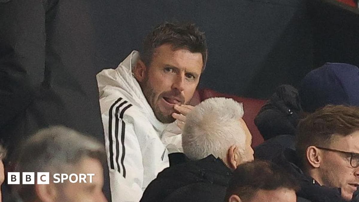 Person in white jacket sitting in audience