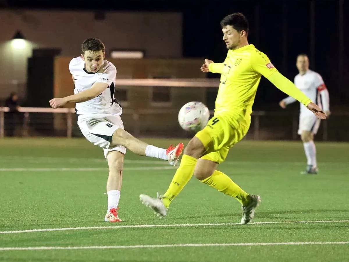 Player shooting while goalkeeper attempts to block