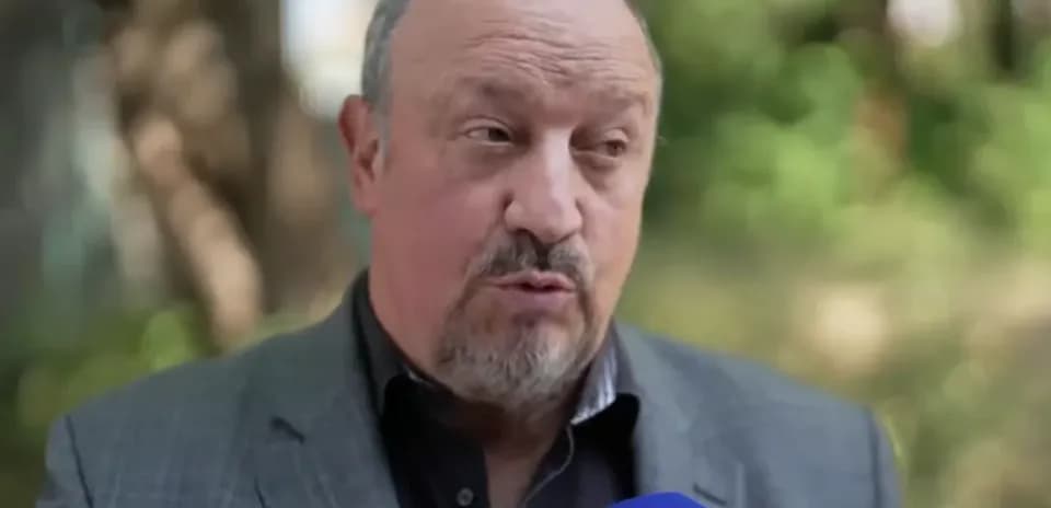 Man speaking into a microphone outdoors