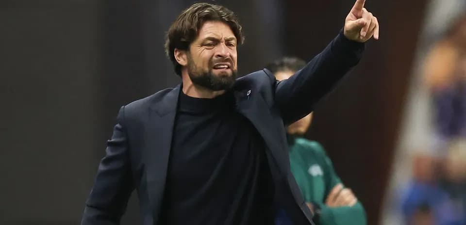 Coach giving instructions from the sidelines during match