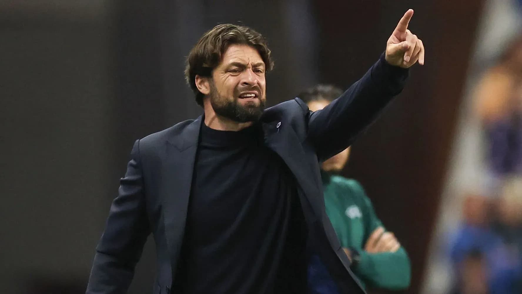 Coach giving instructions from the sidelines during match