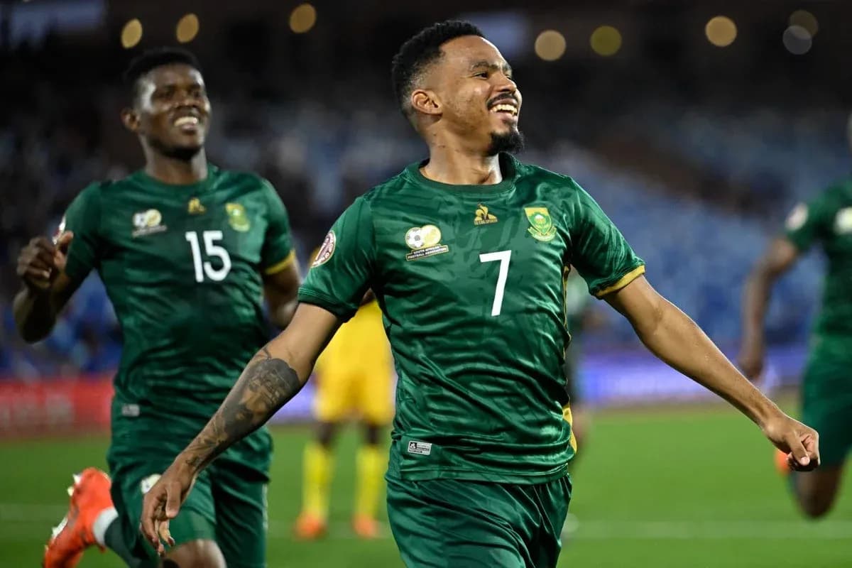 Player celebrating a goal with teammates on field