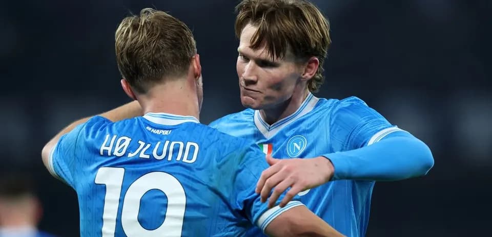Two Napoli players celebrating a goal together