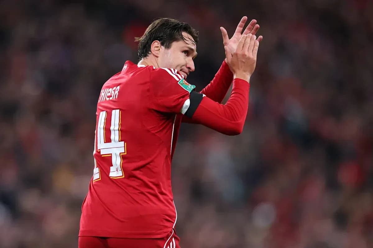Player applauding fans during match in red jersey