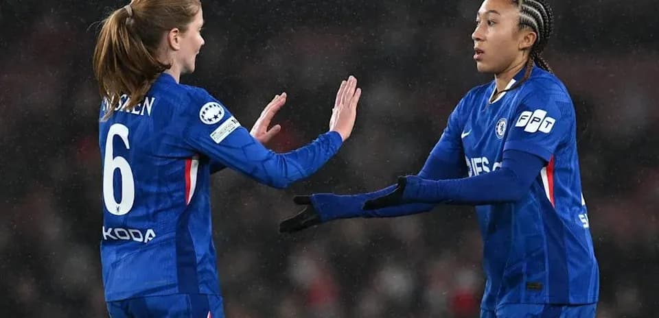 Two Chelsea players exchanging high-fives on field