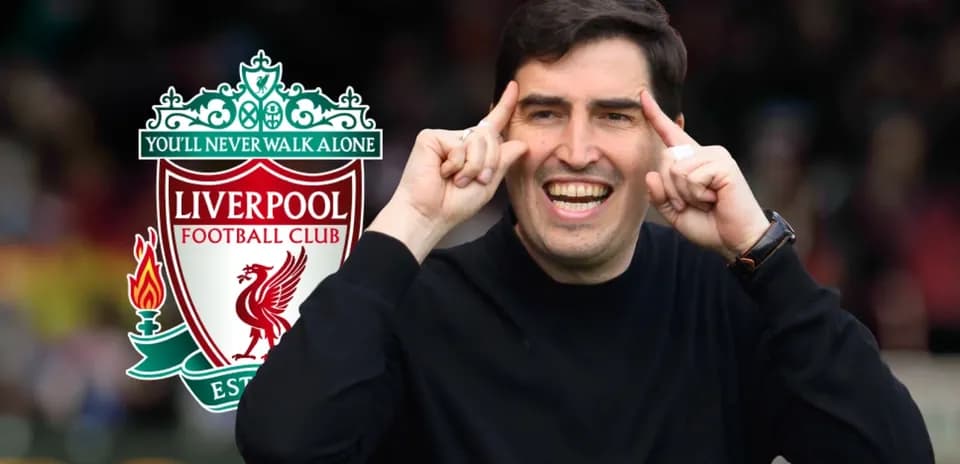 Coach gesturing with Liverpool FC logo in background