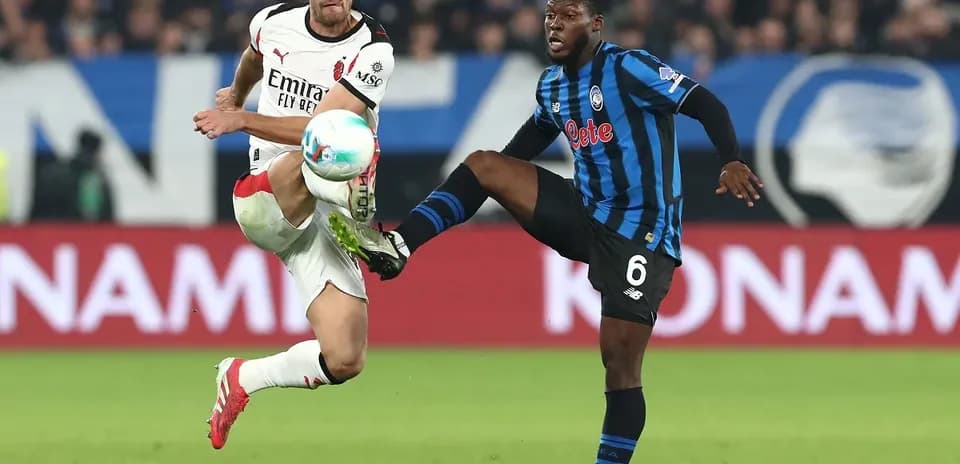 AC Milan player challenging Atalanta opponent