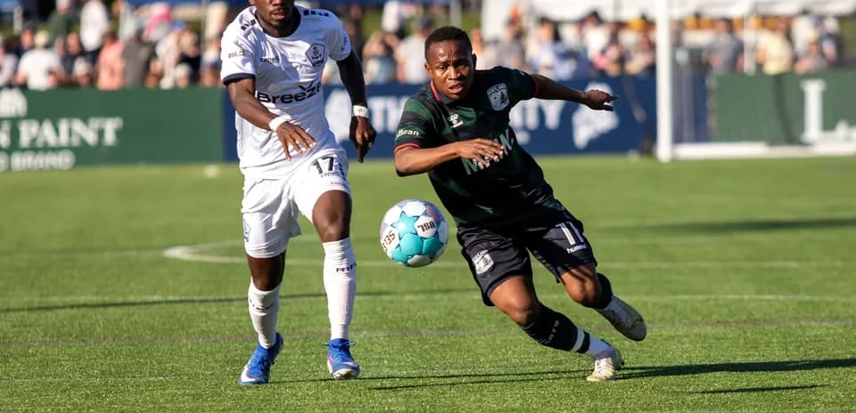Players competing for the ball in USL match