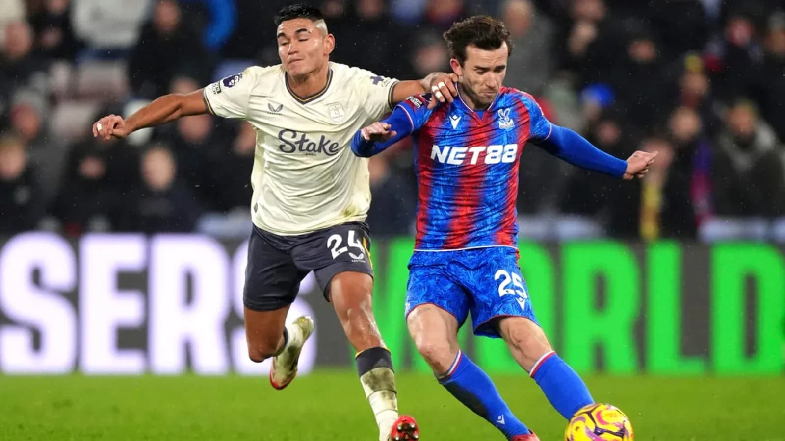 Crystal Palace player tackling Everton opponent
