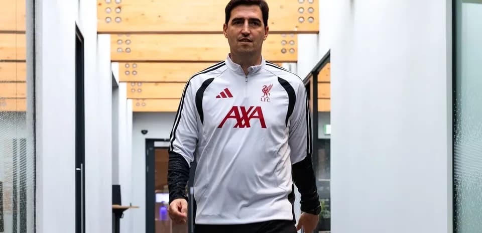 Liverpool coach walking through training facility hallway