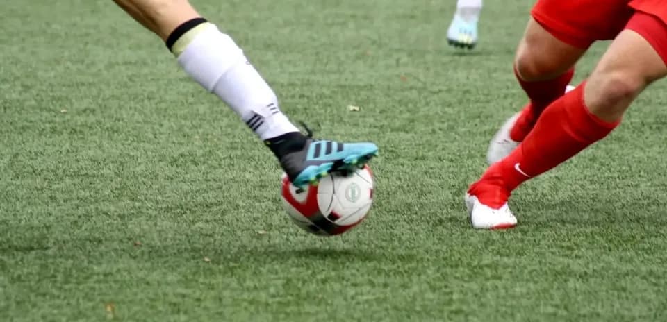 Players competing for the ball during football match