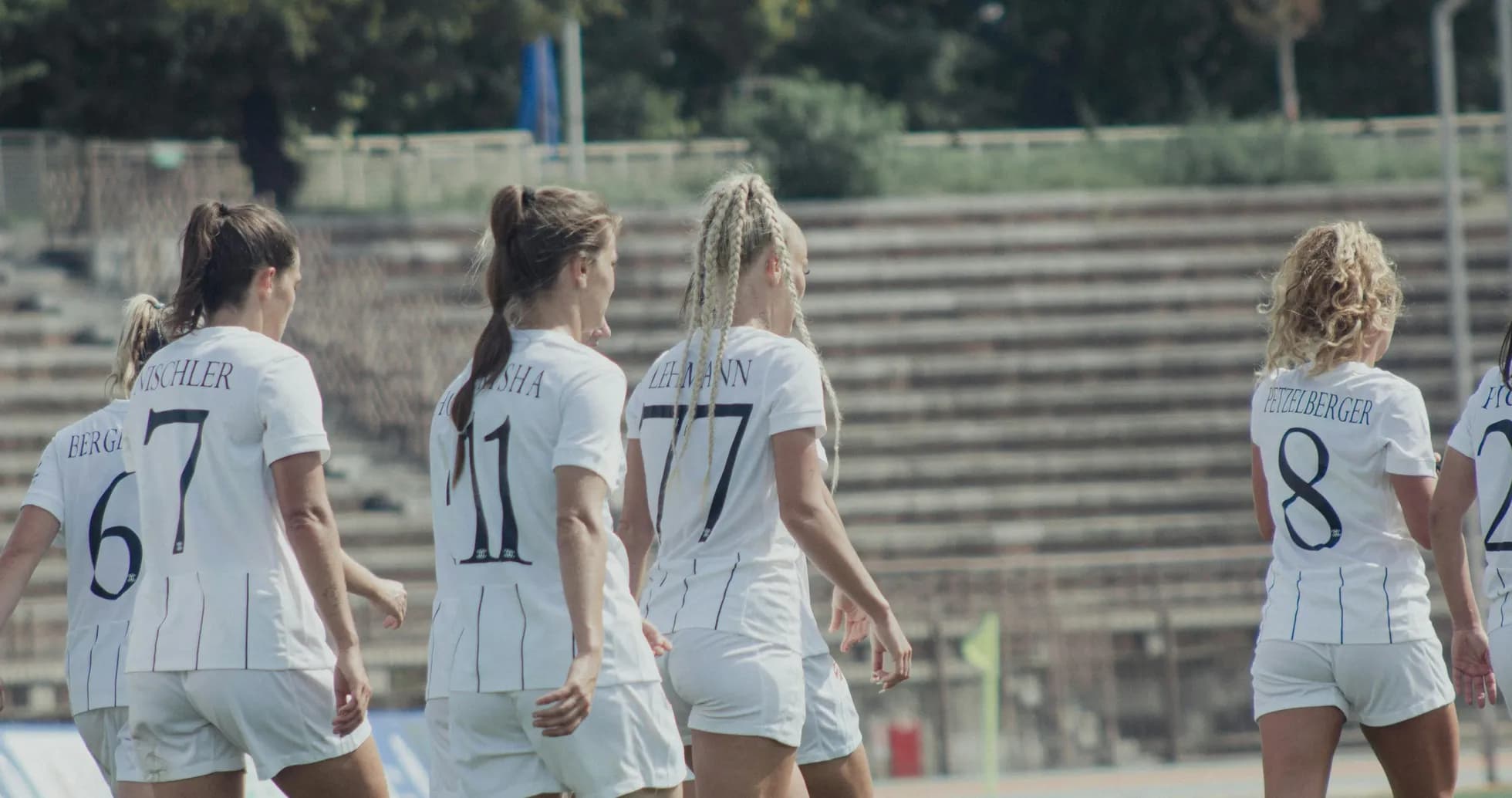 Women players walking on football field