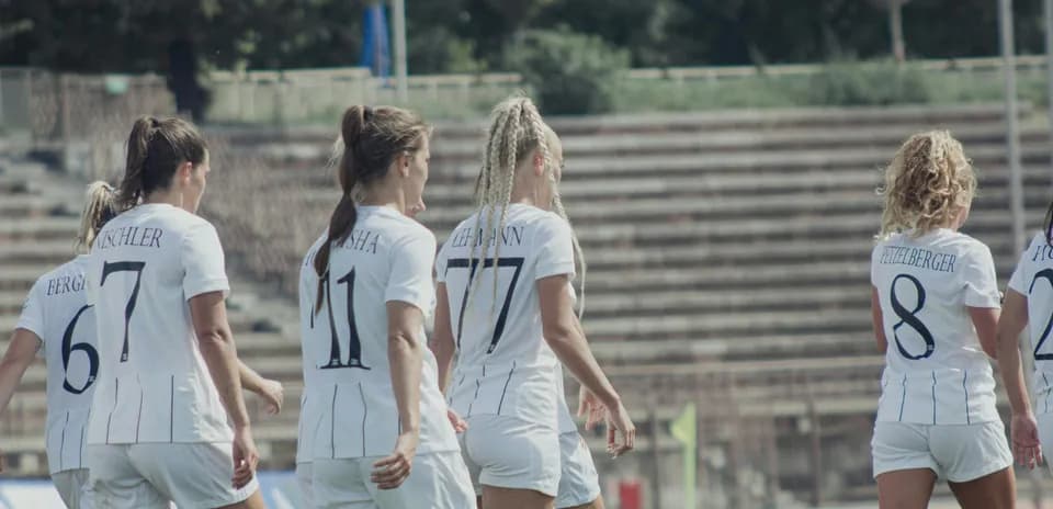 Women players walking on football field