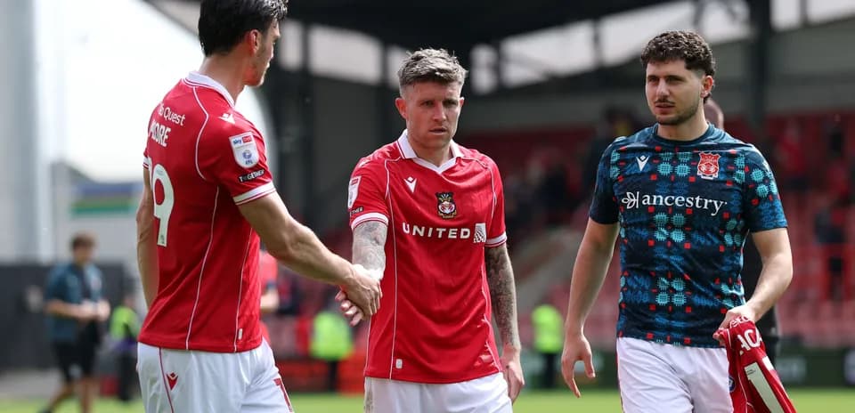 Three players shaking hands after the match