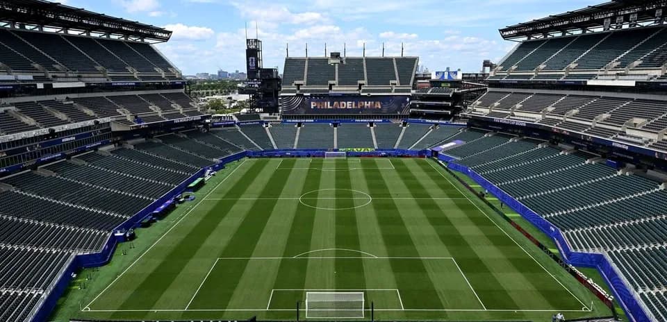 Empty soccer stadium with well-maintained pitch
