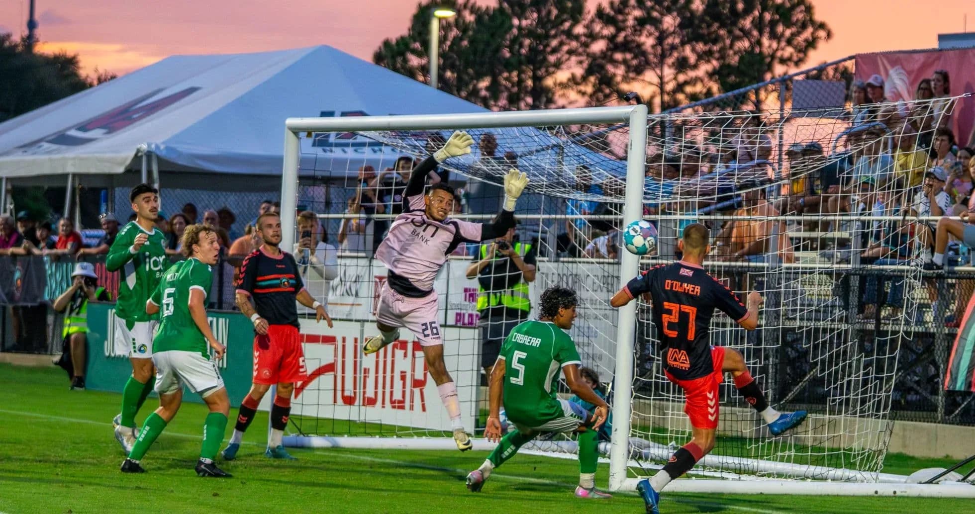 Goalkeeper attempting to save a shot in match