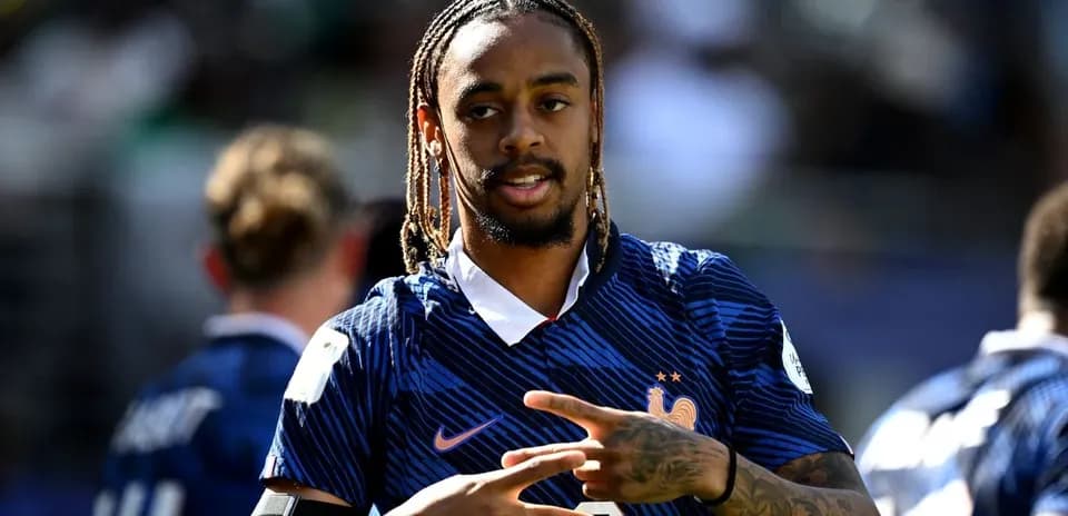 Player in France jersey making hand gesture