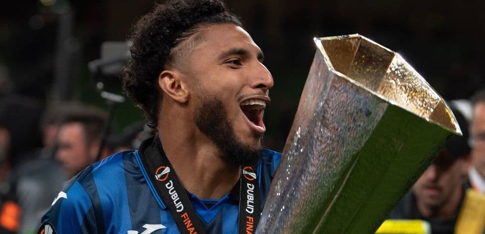 Player celebrating with trophy after winning final