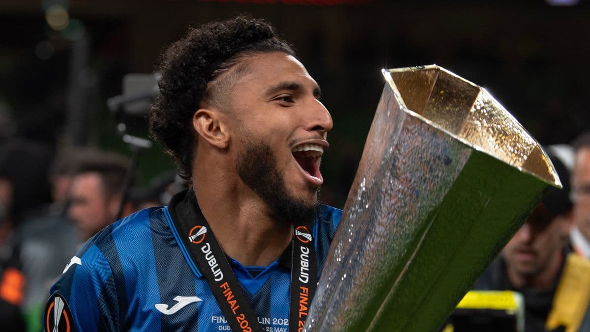 Player celebrating with trophy after winning final