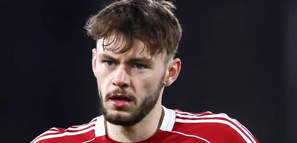 Player in red jersey looking directly at camera