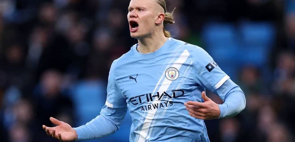 Player gesturing during match wearing light blue jersey