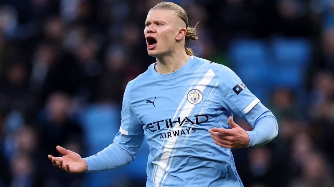 Player gesturing during match wearing light blue jersey