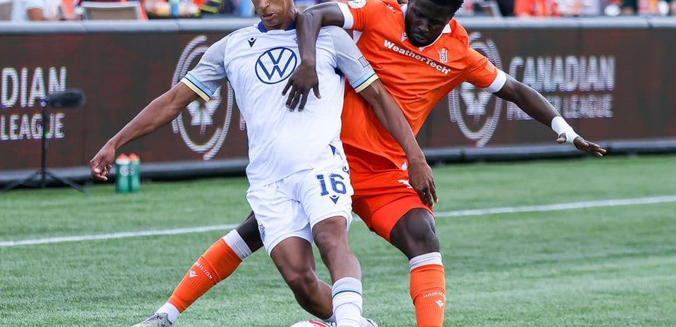 Players contesting for the ball in football match