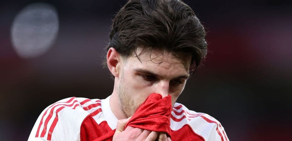 Player looking down while holding jersey close